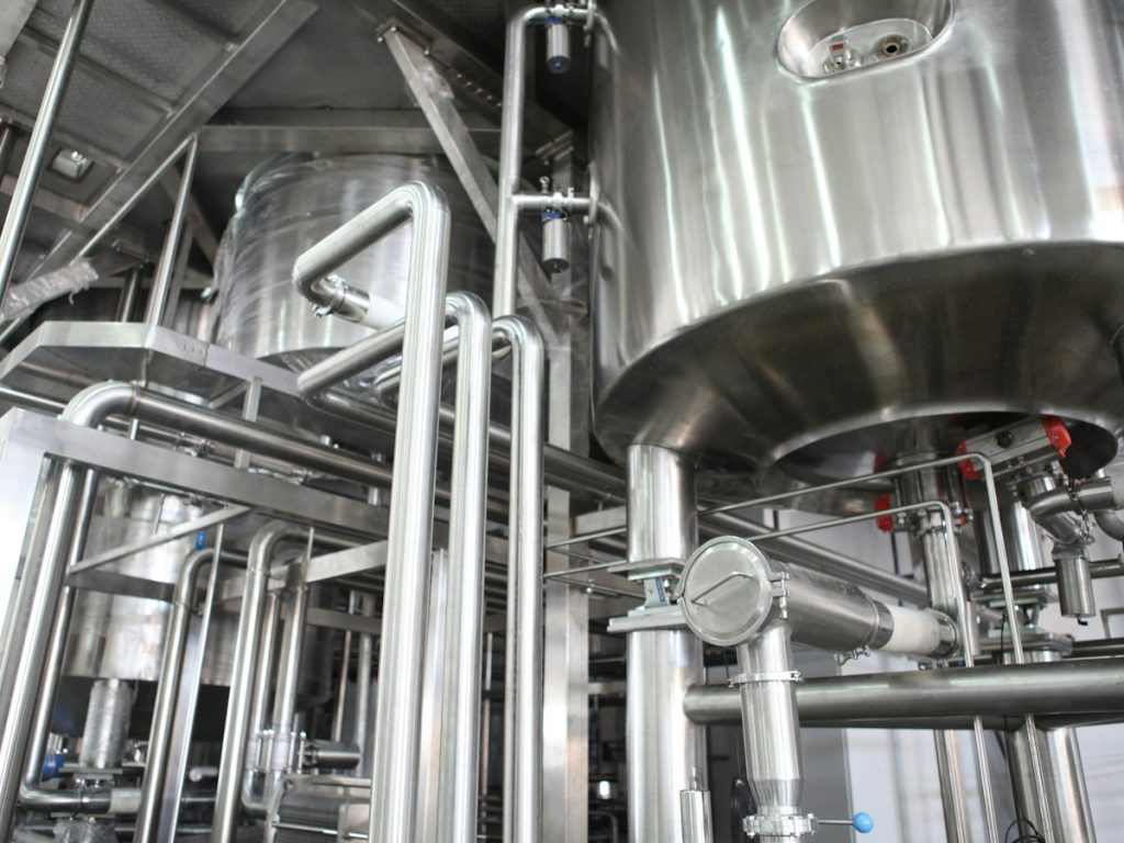 Stainless steel process tanks and sanitary piping in a production plant