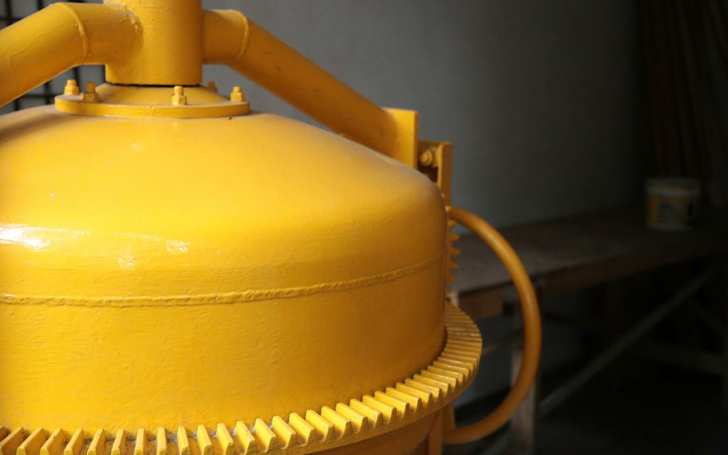 Yellow domed pressure vessel with piping connections