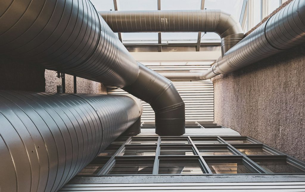 Large spiral steel ventilation ducts running up an exterior wall