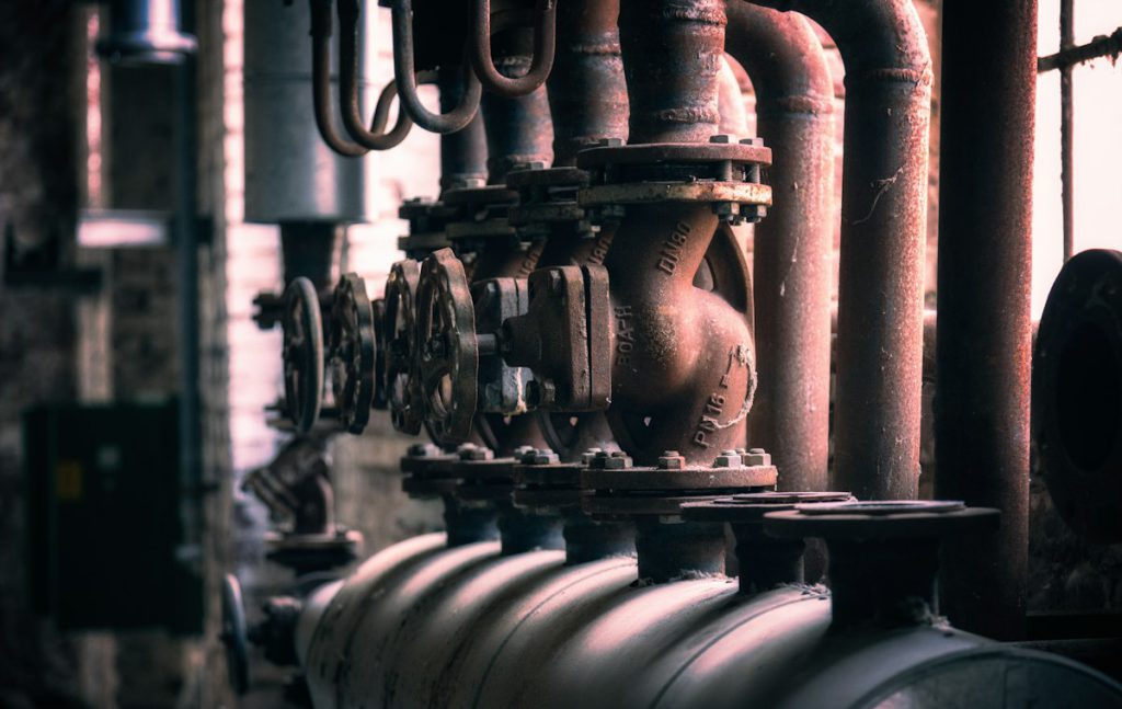 Heavy flanged pipes and valves in a plant room