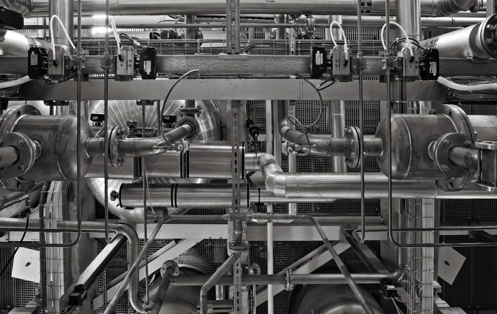 Network of industrial metal pipes and valves in a plant