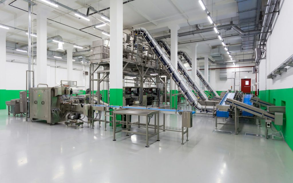 Stainless steel conveyors and processing equipment on a clean food production floor